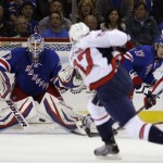 Washington Capitals defenseman Karl Alzner (27) takes a shot as New York Rangers goalie Henrik Lundqvist (30), of Sweden, defends the crease in the second period of Game 3 of their first-round NHL hockey Stanley Cup playoff series in New York, Monday, May 6, 2013. (AP Photo/Kathy Willens)