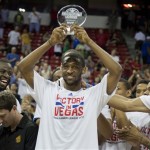 Golden State Warriors' Ian Clark, center, is congratulated by teammates as he holds up the MVP trophy for the NBA Summer League championship game, Monday, July 22, 2013, in Las Vegas. The Warriors beat the Phoenix Suns 91-77. (AP Photo/Julie Jacobson)