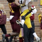 Minnesota defensive back Eric Murray (31) breaks up a pass intended for Iowa wide receiver Kevonte Martin-Manley, right, during the second quarter of an NCAA college football game on Saturday, Sept. 28, 2013, in Minneapolis. (AP Photo/Ann Heisenfelt)