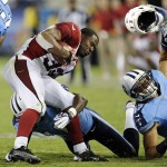 Arizona Cardinals running back William Powell (33) loses his helmet as he is stopped by Tennessee Titans defenders LaQuinton Evans, center, and Aaron Francisco, right, in the fourth quarter of an NFL football preseason game, Thursday, Aug. 23, 2012, in Nashville, Tenn. The Titans won 32-27. (AP Photo/Joe Howell)