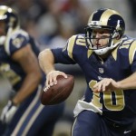 St. Louis Rams quarterback Kellen Clemens (10) scrambles against a Seattle Seahawks defense during the first half of an NFL football game, Monday, Oct. 28, 2013, in St. Louis. (AP Photo/Michael Conroy)