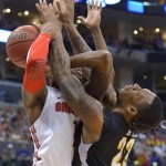 Ohio State forward Deshaun Thomas, left, and Wichita State forward Carl Hall get tangled up during the second half of the West Regional final in the NCAA men's college basketball tournament, Saturday, March 30, 2013, in Los Angeles. (AP Photo/Mark J. Terrill)