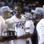 Miami Heat players Ray Allen (34), left, holds the NBA Eastern Conference trophy as Chris Bosh hold his son Jackson and Dwyane Wade and LeBron James smile. The Heat defeated the Pacers 99-76 to advance to the NBA finals against the San Antonio Spurs. (AP Photo/Lynne Sladky)
