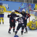 Brianna Decker of the United States (14), Kendall Coyne (26) and Amanda Kessel celebrate a goal by Decker against Sweden during the third period of the 2014 Winter Olympics women's semifinal ice hockey game at Shayba Arena, Monday, Feb. 17, 2014, in Sochi, Russia. The USA won 6-1.(AP Photo/Matt Slocum)