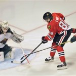 Minnesota Wild's Josh Harding makes the save on a shot by Chicago Blackhawks' Patrick Kane (88) during the third period of Game 1 of an NHL hockey Stanley Cup playoff series Tuesday, April 30, 2013, in Chicago. At right is Wild's Marco Scandella. (AP Photo/Jim Prisching)