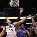 Sacramento Kings' Jason Thompson (34) gets off a shot over Phoenix Suns' Luis Scola (14), of Argentina, during the first half of an NBA preseason basketball game, Monday, Oct. 22, 2012, in Phoenix. (AP Photo/Ross D. Franklin)