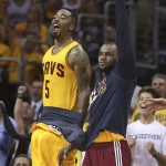 
              Cleveland Cavaliers guard J.R. Smith (5) and forward LeBron James react late in the second half of Game 4 of the NBA basketball Eastern Conference finals against the Atlanta Hawks, Tuesday, May 26, 2015, in Cleveland.  The Cavaliers won 118-88. (AP Photo/Ron Schwane)
            