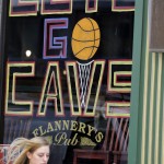 
              In this photo taken, Friday, June 5, 2015, a woman walks past "Let's Go Cavs" signage on a pub in Cleveland. Behold a new, shining Cleveland, once dubbed the Mistake on the Lake. Well, times have changed, and so have the attitudes of skeptical and cynical Cleveland fans, many of whom grew up hoping for the best, expecting the worst and agonizing through moments that have earned dubious nicknames: Red Right 88, The Drive, The Fumble, The Shot, The Move, The Decision. One man has transformed this town. LeBron James has Cleveland believing. (AP Photo/Tony Dejak)
            