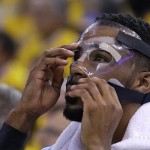 
              FILE - In this May 5, 2015, file photo, Memphis Grizzlies guard Mike Conley adjusts his mask during the first half of Game 2 in a second-round NBA playoff basketball series against the Golden State Warriors in Oakland, Calif. Conley's gritty comeback got the Memphis Grizzlies on track and stole home-court advantage away from the Golen State Warriors in their Western Conference series. (AP Photo/Ben Margot, File)
            