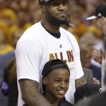 
              Cleveland Cavaliers forward LeBron James listens during the trophy presentation with his oldest son, LeBron James Jr., after the Cavaliers defeated the Atlanta Hawks 118-88 in Game 4 of the NBA basketball Eastern Conference finals, Tuesday, May 26, 2015, in Cleveland. (AP Photo/Tony Dejak)
            