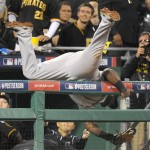 San Francisco Giants third baseman Pablo Sandoval flips over the dugout railing after making a catch on a fly ball by Pittsburgh Pirates' Andrew McCutchen in the seventh inning of the NL wild-card playoff baseball game Wednesday, Oct. 1, 2014, in Pittsburgh. (AP Photo/Don Wright)