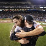 San Francisco Giants starting pitcher Madison Bumgarner, left, hugs a teammate after the Giants defeated the Pittsburgh Pirates 8-0 in the NL wild-card playoff baseball game Wednesday, Oct. 1, 2014, in Pittsburgh. (AP Photo/Gene Puskar)
