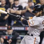 San Francisco Giants' Brandon Crawford hits a grand slam off Pittsburgh Pirates starting pitcher Edinson Volquez during the fourth inning of the NL wild-card playoff baseball game Wednesday, Oct. 1, 2014, in Pittsburgh. (AP Photo/Gene J. Puskar)