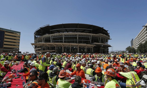 FILE – In this April 7, 2015, file photo, construction works eat lunch by an MGM arena being ...