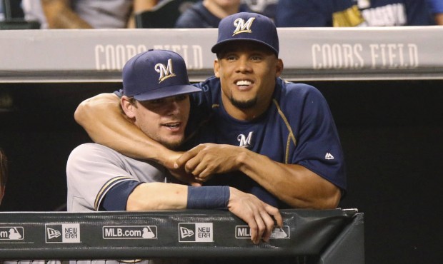 Milwaukee Brewers’ Carlos Gomez, right, jokes with second baseman Scooter Gennett as they lea...