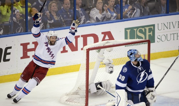New York Rangers center Dominic Moore, left, celebrates after defenseman Keith Yandle scored a goal...