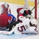 
              Ottawa Senators' Cody Ceci collides with Montreal Canadiens goaltender Carey Price during the second period of Game 5 of a first-round NHL hockey playoff series, Friday, April 24, 2015, in Montreal. (Graham Hughes/The Canadian Press via AP)
            