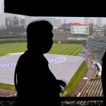
              Event supervisors at Wrigley Field look over the field after rain postponed a baseball game between the Chicago Cubs and the Cleveland Indians, Monday, June 15, 2015, in Chicago. (AP Photo/Matt Marton)
            
