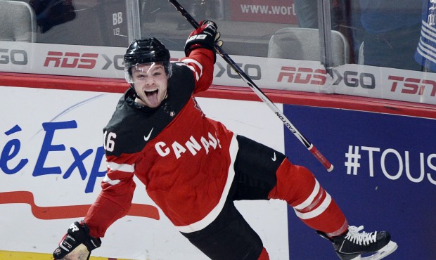 Canada’s Max Domi celebrates after scoring the fifth goal against the United during the third...