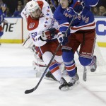 
              New York Rangers right wing Jesper Fast (19) keeps the puck away from Washington Capitals defenseman Mike Green (52) during the second period of Game 1 in the second round of the NHL Stanley Cup hockey playoffs Thursday, April 30, 2015, in New York. (AP Photo/Frank Franklin II)
            
