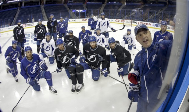 Tampa Bay Lightning head coach Jon Cooper talks to his team during practice at the NHL hockey Stanl...