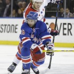 
              New York Rangers right wing Martin St. Louis (26) seals off Washington Capitals defenseman John Carlson (74) from the puck during the first period of Game 1 in the second round of the NHL Stanley Cup hockey playoffs Thursday, April 30, 2015, in New York. (AP Photo/Frank Franklin II)
            