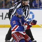 
              New York Rangers defenseman Dan Boyle (22) waits for a trainer with linesman Pierre Racicot (65) after an injury during the third period of Game 7 of the Eastern Conference semifinals during the NHL hockey Stanley Cup playoffs, Wednesday, May 13, 2015, in New York. (AP Photo/Kathy Willens)
            