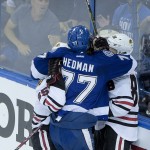 
              Tampa Bay Lightning defenseman Victor Hedman, middle, said he might have been bitten by Chicago Blackhawks center Andrew Shaw, left, while in a scrum with Patrick Kane during the first period in Game 1 of the NHL hockey Stanley Cup Final in Tampa, Fla., Wednesday, June 3, 2015.  (AP Photo/Phelan M. Ebenhack)
            