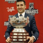 
              Patrice Bergeron of the Boston Bruins holds up the Frank J. Selke Trophy after winning the award at the NHL Awards show Wednesday, June 24, 2015, in Las Vegas. (AP Photo/John Locher)
            