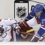 
              Washington Capitals left wing Alex Ovechkin (8) and New York Rangers defenseman Ryan McDonagh (27) fall to the ice during the second period of Game 1 in the second round of the NHL Stanley Cup hockey playoffs Thursday, April 30, 2015, in New York. (AP Photo/Frank Franklin II)
            