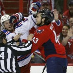 
              Linesman Bryan Pancich (94) works to separate New York Rangers center J.T. Miller, left, and Washington Capitals right wing Tom Wilson (43) during a scuffle in the first period of Game 4 in the second round of the NHL Stanley Cup hockey playoffs, Wednesday, May 6, 2015, in Washington. (AP Photo/Alex Brandon)
            