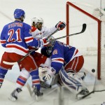
              Washington Capitals right wing Joel Ward, middle, collides with New York Rangers goalie Henrik Lundqvist (30) as he knocks the puck into the goal near New York Rangers center Derek Stepan (21) during the second period of Game 5 in the second round of the NHL Stanley Cup hockey playoffs, Friday, May 8, 2015, in New York. The goal was waved off by the officials because of contact made with the goalie. (AP Photo/Julie Jacobson)
            