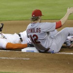 
              Miami Marlins' Giancarlo Stanton, left, is safe at first base after St. Louis Cardinals first baseman Mark Reynolds (12) was unable to hang on to the throw during the seventh inning of a baseball game, Wednesday, June 24, 2015, in Miami. (AP Photo/Wilfredo Lee)
            