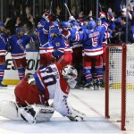 
              The New York Rangers celebrate the game winning goal by center Derek Stepan (21) against the Washington Capitals as Capitals goalie Braden Holtby looks at the puck in the net in overtime of Game 7 of the Eastern Conference semifinals during the NHL hockey Stanley Cup playoffs, Wednesday, May 13, 2015, in New York. The Rangers won 2-1. (AP Photo/Kathy Willens)
            