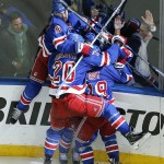 
              The New York Rangers celebrate their game winning overtime goal against the Washington Capitals in Game 7 of the Eastern Conference semifinals during the NHL hockey Stanley Cup playoffs, Wednesday, May 13, 2015, in New York. (AP Photo/Julie Jacobson)
            