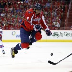
              Washington Capitals left wing Alex Ovechkin (8), from Russia, jumps over a teammate's shot as New York Rangers defenseman Kevin Klein, right, defends during the first period of Game 4 in the second round of the NHL Stanley Cup hockey playoffs, Wednesday, May 6, 2015, in Washington. (AP Photo/Alex Brandon)
            