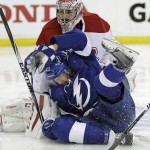 
              Tampa Bay Lightning right wing J.T. Brown (23) crashes into Montreal Canadiens goalie Carey Price during the second period of Game 6 of a second-round NHL Stanley Cup hockey playoff series Tuesday, May 12, 2015, in Tampa, Fla. (AP Photo/Chris O'Meara)
            