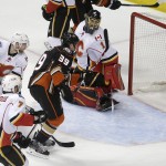 
              Anaheim Ducks' Matt Beleskey, center, watches his shot enter the net past Calgary Flames goalie Jonas Hiller, top, of Switzerland, during the first period of Game 1 in the second round of the NHL Stanley Cup hockey playoffs, Thursday, April 30, 2015, in Anaheim, Calif. (AP Photo/Jae C. Hong)
            