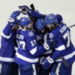 
              Tampa Bay Lightning defenseman Jason Garrison (5) celebrates his goal with his teammates against the Chicago Blackhawks during the third period in Game 2 of the NHL hockey Stanley Cup Final on Saturday, June 6, 2015, in Tampa Fla. (AP Photo/John Raoux)
            