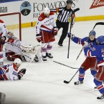 
              New York Rangers defenseman Ryan McDonagh, bottom right, celebrates with Rangers' Chris Kreider, right, and Jesper Fast after McDonagh scored the game-winning goal in overtime against the Washington Capitals during Game 5 in the second round of the NHL Stanley Cup hockey playoffs, Friday, May 8, 2015, in New York. The Rangers won 2-1. (AP Photo/Julie Jacobson)
            