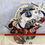 
              Chicago Blackhawks' Jonathan Toews, bottom, falls into the net past Tampa Bay Lightning goalie Ben Bishop during the first period in Game 3 of the NHL hockey Stanley Cup Final on Monday, June 8, 2015, in Chicago. (AP Photo/Nam Y. Huh)
            