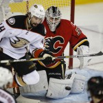 
              Anaheim Ducks' Nate Thompson, left, looks on as Calgary Flames goalie Karri Ramo, from Finland, stops a shot during the second period of Game 4 of NHL hockey second-round playoff action in Calgary, Alberta, Friday, May 8, 2015. (Jeff McIntosh/The Canadian Press via AP) MANDATORY CREDIT
            