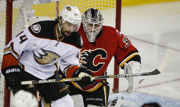 Anaheim Ducks’ Nate Thompson, left, looks on as Calgary Flames goalie Karri Ramo, from Finlan...