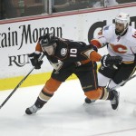 
              Anaheim Ducks' Corey Perry, left, moves the puck past Calgary Flames' Deryk Engelland during the second period of Game 2 in the second round of the NHL Stanley Cup hockey playoffs, Sunday, May 3, 2015, in Anaheim, Calif. (AP Photo/Jae C. Hong)
            