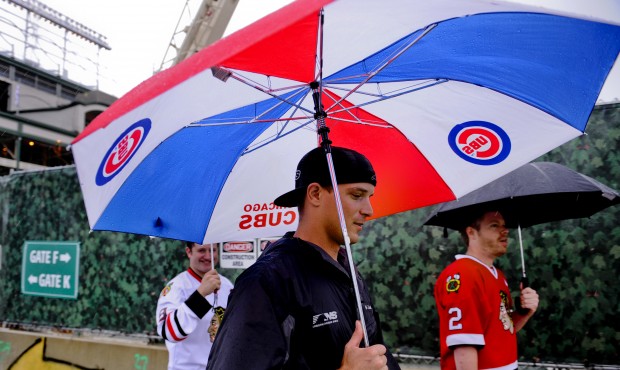 Fans leave Wrigley Field after rain postponed a baseball game between the Chicago Cubs and the Clev...