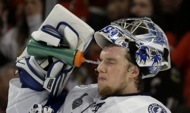 Tampa Bay Lightning goalie Andrei Vasilevskiy sprays his face during the second period in Game 4 of...