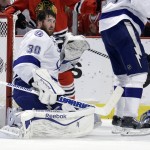 
              Tampa Bay Lightning goalie Ben Bishop looks off after losing his helmet during the second period in Game 6 of the NHL hockey Stanley Cup Final series against the Chicago Blackhawks on Monday, June 15, 2015, in Chicago. (AP Photo/Nam Y. Huh)
            
