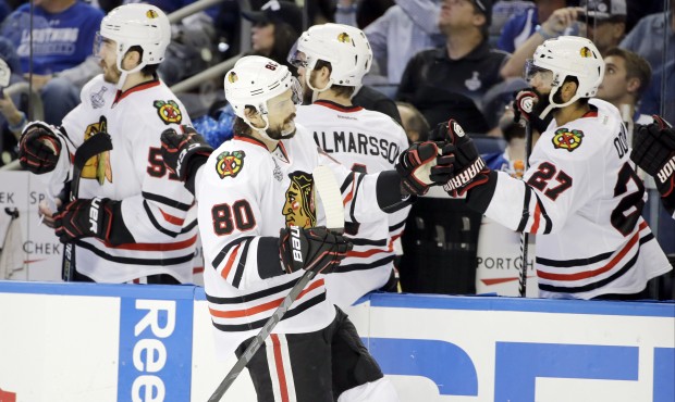 Chicago Blackhawks center Antoine Vermette (80) is congratulated by teammates after scoring against...