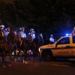 
              Chicago Police officers on horseback drive Chicago Blackhawks fans down Addison Street while celebrating in the Wrigleyville neighborhood after the Chicago Blackhawks won the Stanley Cup, defeating the Tampa Bay Lightning Monday, June 15, 2015 in Chicago. (AP Photo/Christian K. Lee)
            