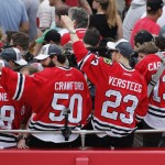 
              Chicago Blackhawks' Patrick Kane (88), Corey Crawford (50), Kris Versteeg (23) and Daniel Carcillo, ride in a parade celebrating the NHL hockey club's Stanley Cup championship, Thursday, June 18, 2015, in Chicago. (AP Photo/Charles Rex Arbogast)
            